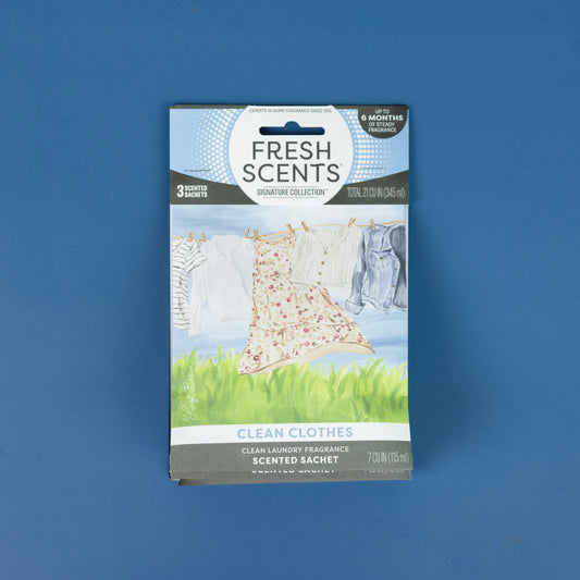 The Fresh Scents Clean Clothes - Sachet 3pk is displayed against a blue background, with packaging showing clothes on a clothesline to illustrate this flameless, long-lasting air freshener.