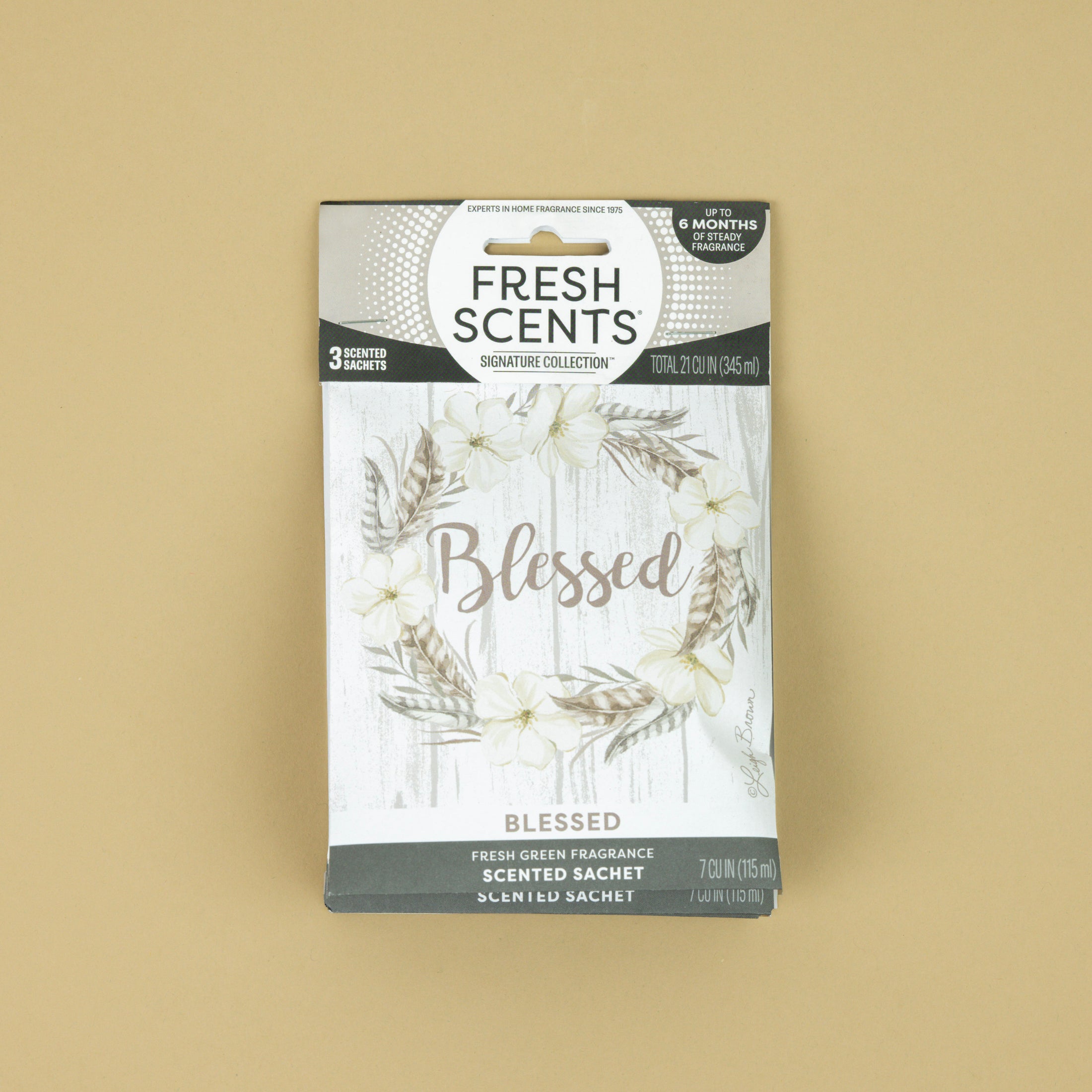 Fresh Scents Blessed Wreath 3pk sachets feature a floral wreath on a light wood background with “Blessed” scripted at the center. Enjoy long-lasting, flameless fragrance in any space.