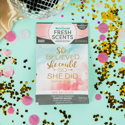 Fresh Scents She Believed - Sachet 3pk: A charming, long-lasting air freshener featuring pastel colors, “She believed she could so she did” on blue, gold confetti, pink dots, and a disco ball—perfect for brightening your space.
