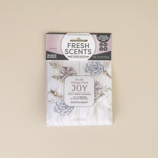 The Fresh Scents In All Things - Sachet 2pk features two floral sachets with a fruity amber scent that lasts up to 9 months, offering a flameless way to add fragrance and joy to any room or small space.