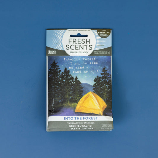 A Fresh Scents Into the Forest - Sachet 3pk is shown on a blue background, featuring packaging with a yellow tent amidst a nighttime forest—highlighting these long-lasting fragrance sachets.